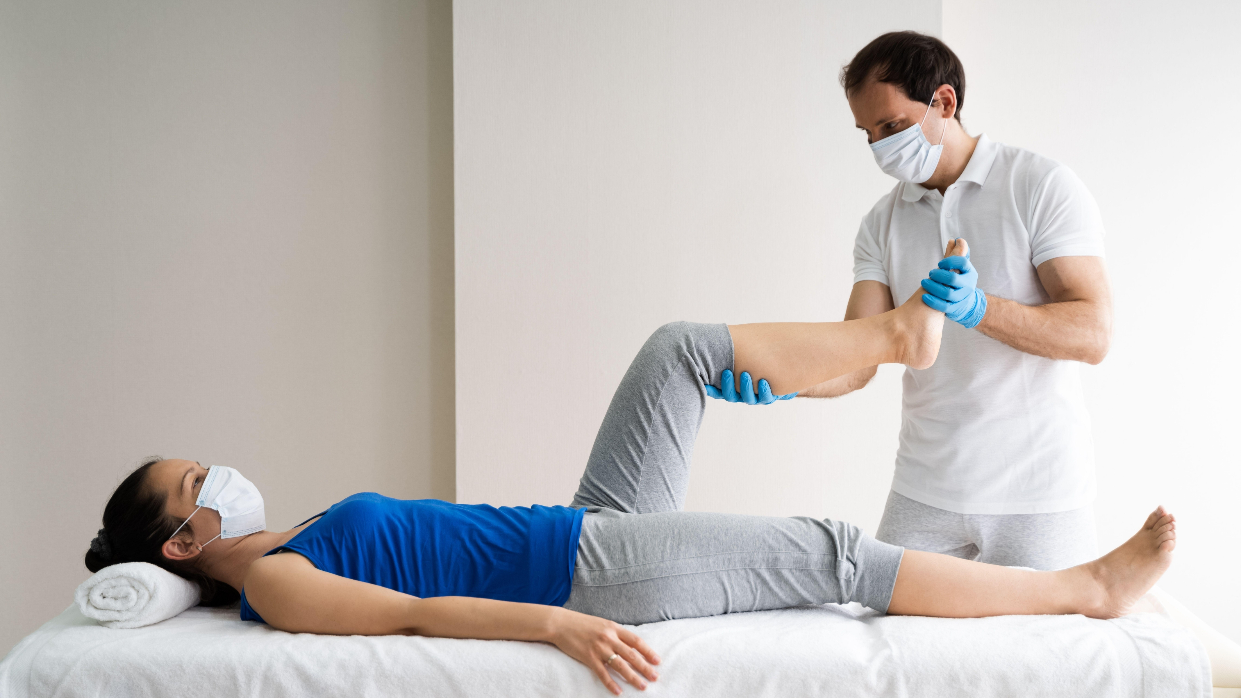 Physiotherapist working with a patient on knee mobility.